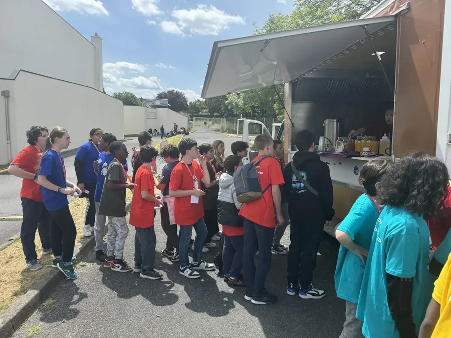 File d'élèves devant le comptoir du food truck Chana Thai lors d'une fête d'école